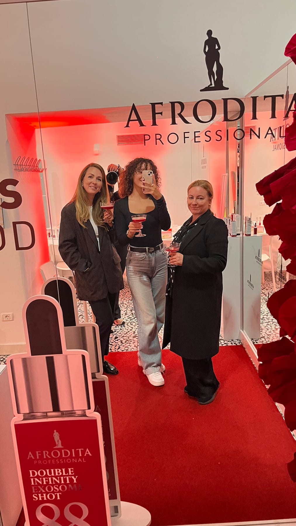 Gostje pred zrcalom z brandingom Afrodita Professional na lansiranju EXO-LIFT v 369 Place Ljubljana
